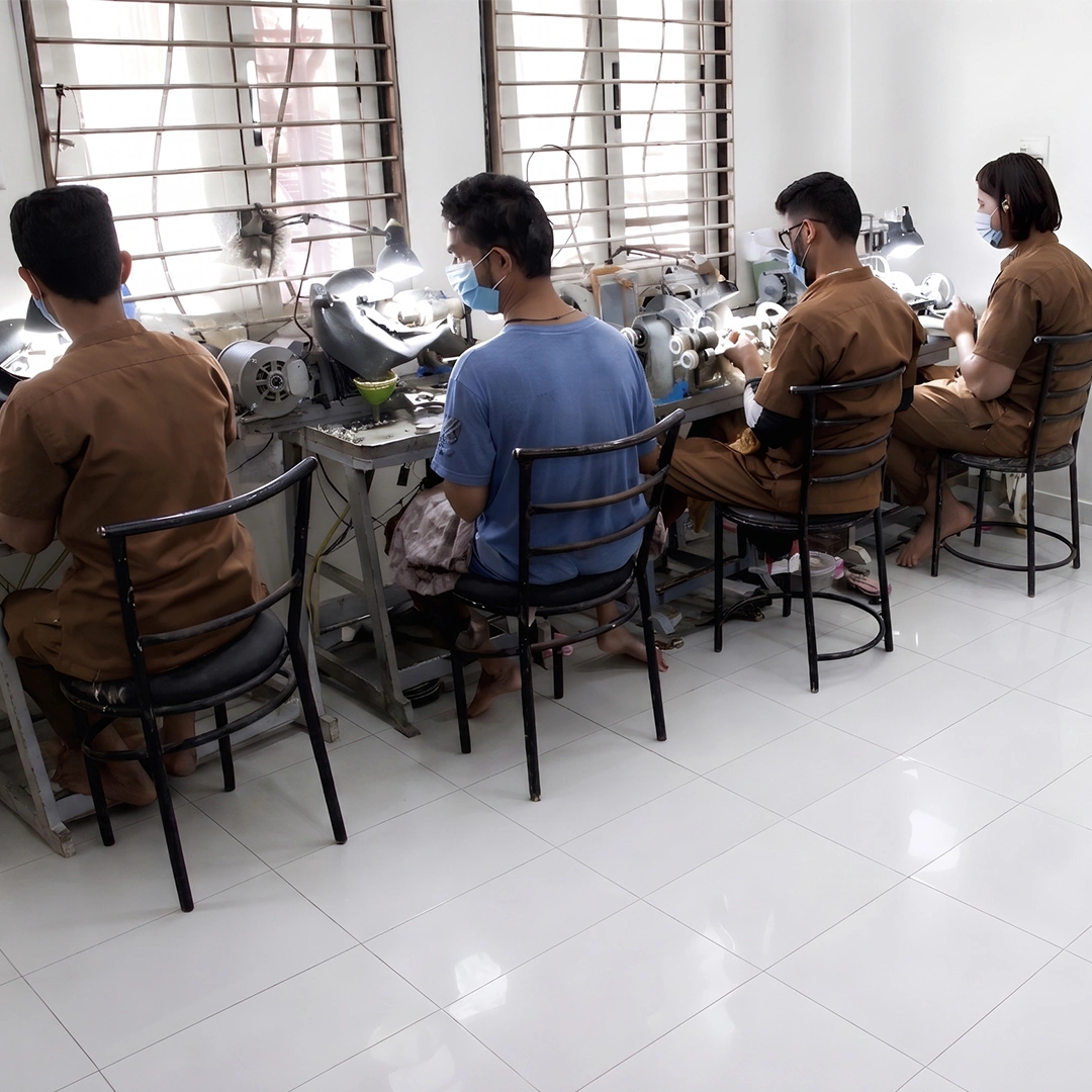 Skilled artisans at jewelry polishing workstations