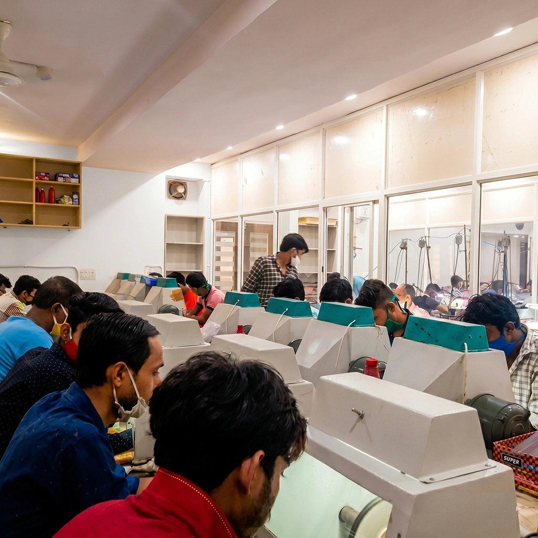 Jewelry artisans at modern production workstations