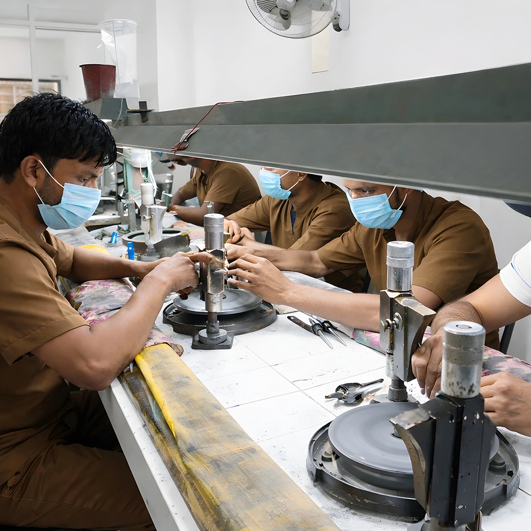 Jewelry artisans polishing stones at workbenches