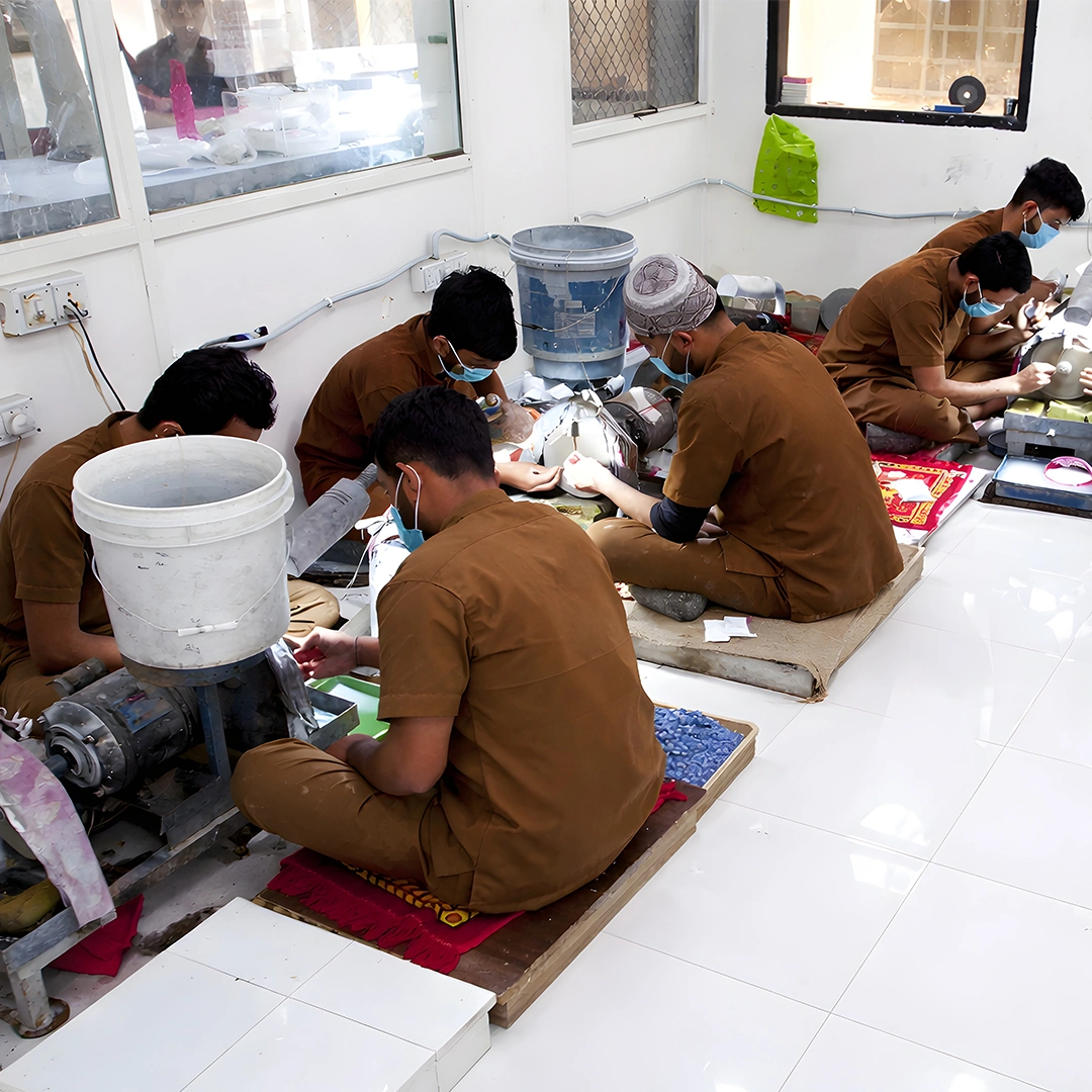 Artisans operating stone polishing machines