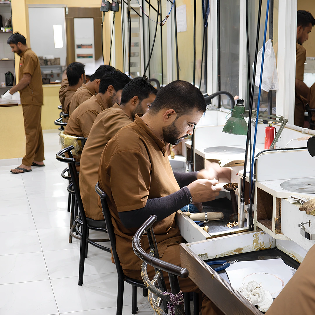 Jewelry artisans working at manufacturing benches