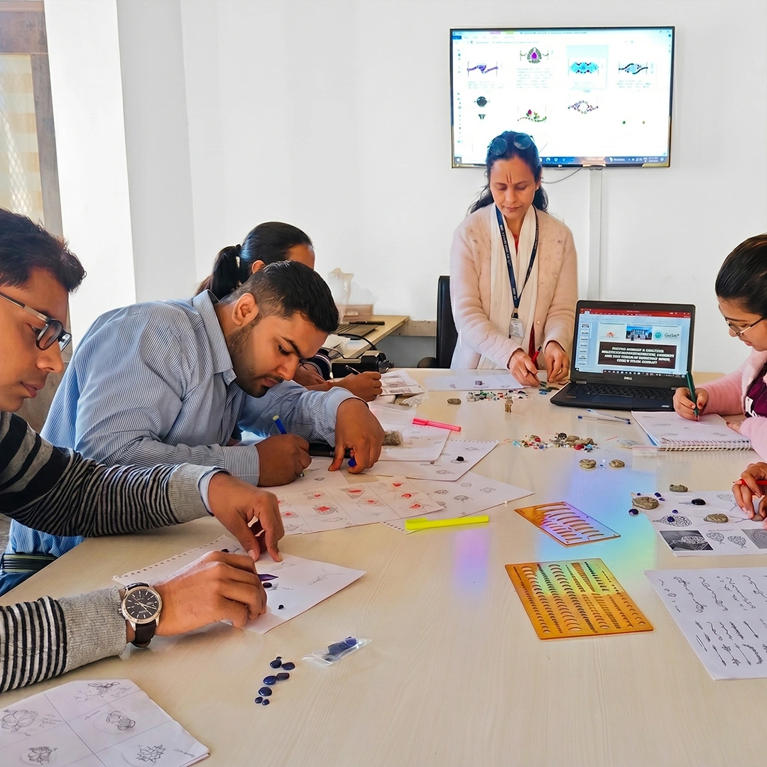 Designers sketching custom jewelry concepts at a table